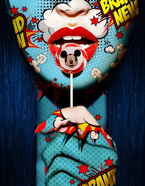 Bright red lips holding a Mickey Mouse lollipop.