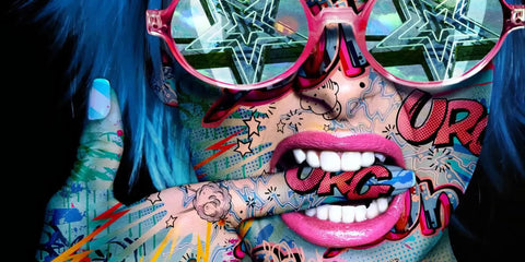 A woman with blue hair and sunglasses on her face