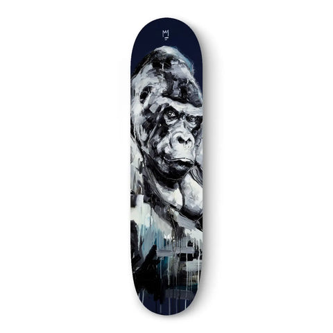 Skateboard deck featuring a striking black and white portrait of a gorilla.