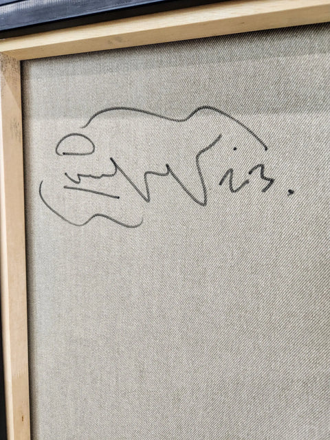 A framed painting of a dog on a wall
