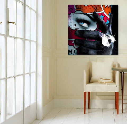 A chair in a room with a painting on the wall