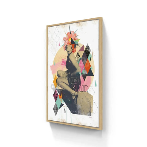 A framed canvas with a woman’s face and colorful geometric shapes