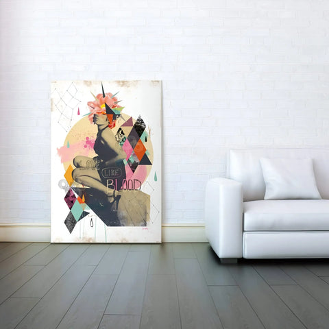 A white couch and a large painting on the wall