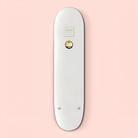 White skateboard deck with a small circular yellow emoji logo.