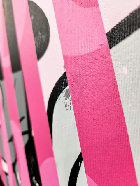 A close up of a pink and black abstract painting