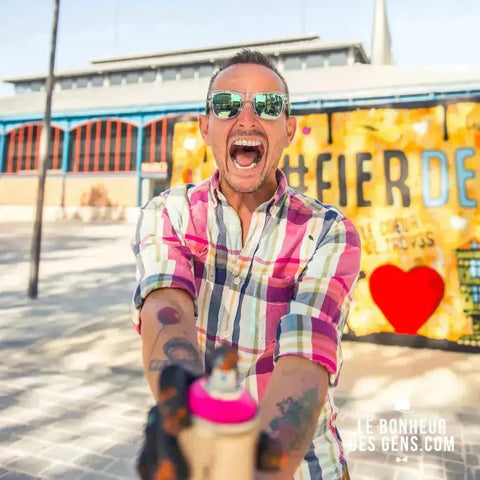 Excited person in a colorful plaid shirt shouting with arms outstretched in Argadol collection