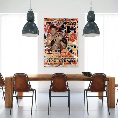 Colorful, collage-style poster featuring a boxer, hung on a white wall between two pendant lights.