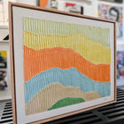 Textured, colorful landscape painting in a wooden frame.