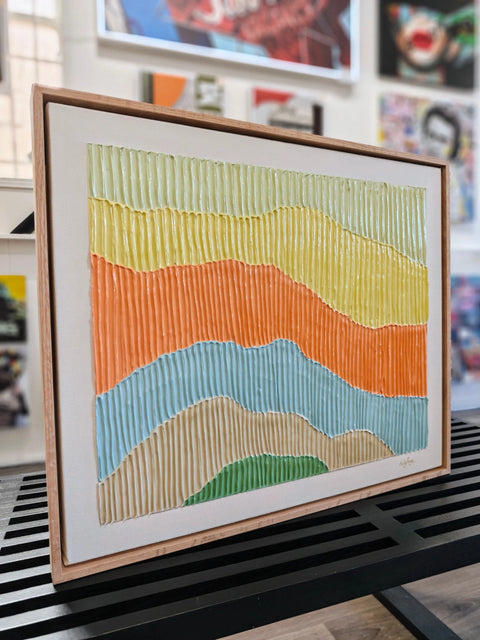 Textured, colorful landscape painting in a wooden frame.