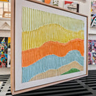 Textured, colorful, framed artwork.