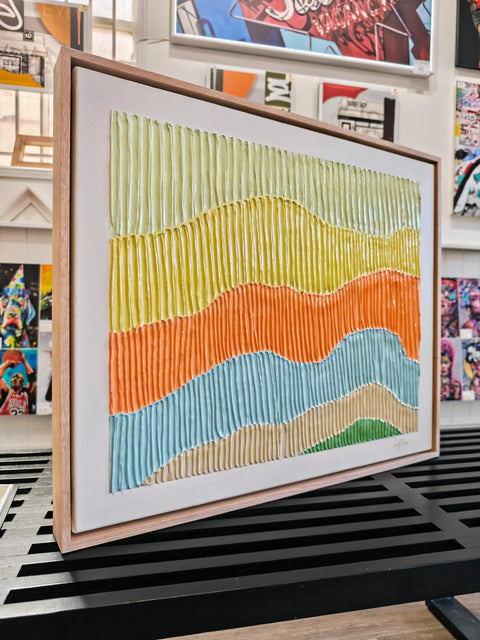 Textured, colorful, framed artwork.