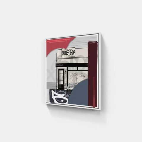 A white wall with a red and black poster on it