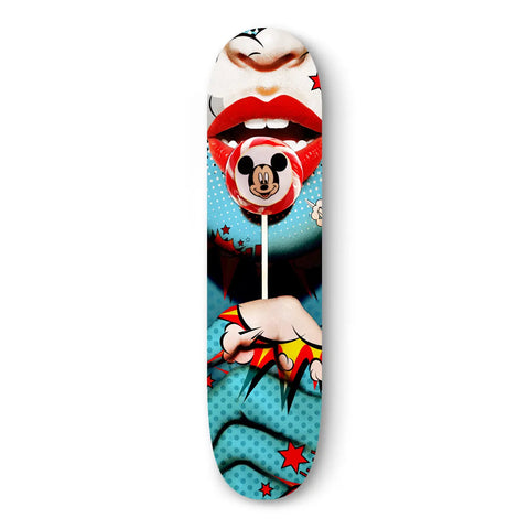 Skateboard deck with pop art-style graphic featuring red lips and a Mickey Mouse lollipop.