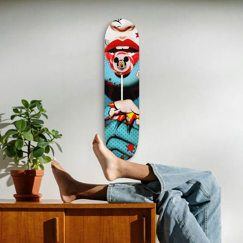Skateboard deck with pop art design featuring Mickey Mouse and red lips.