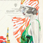 A woman wearing a vibrant orange and white striped headscarf with green accents.