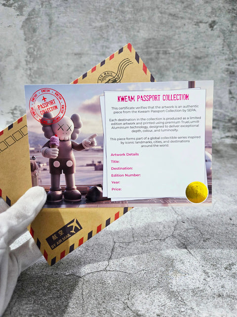 Gray kaws-style egyptian kweam figurine holding ice cream cone with white accents made of original aluminium artwork