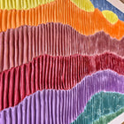 Colorful textile art piece with wavy, pleated fabric strips in various hues arranged horizontally.