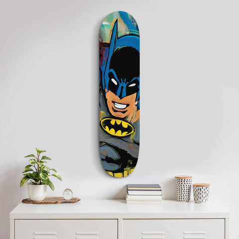 Skateboard deck featuring a colorful Batman comic-style artwork.