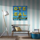 A room with a chair and a painting on the wall