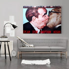A couch with a painting of a man kissing a woman