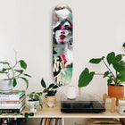 Artistic skateboard deck featuring a stylized portrait in black, white, and pink tones with mint green accents.
