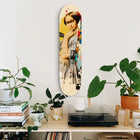 Decorative skateboard deck mounted on a wall featuring vintage-style artwork.
