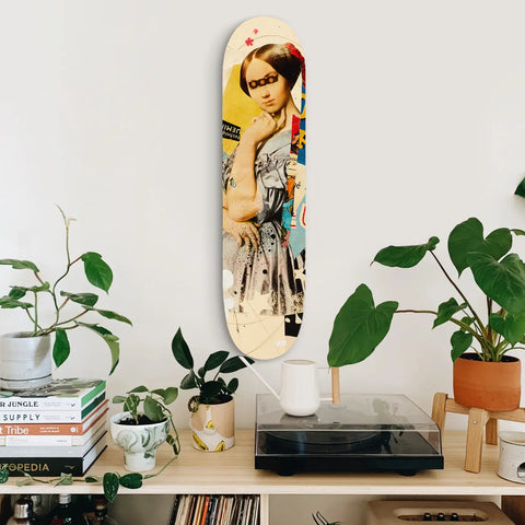 Decorative skateboard deck mounted on a wall featuring vintage-style artwork.
