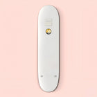White skateboard deck with a small circular yellow emoji logo.