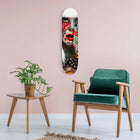 Skateboard deck with colorful graffiti-style artwork featuring a screaming face.