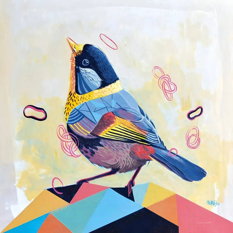 Colorful bird with blue, yellow, and red plumage perched on a geometric shape.