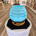 Light blue, ribbed ceramic vase or planter with a handle.
