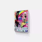 A painting on a wall with a woman’s face