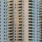 A tall building with many windows and bales