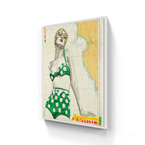 A framed vintage-style artwork of a woman in green floral bikini on a nautical map in st yves limited edition aluminium frame