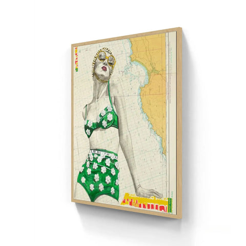 A framed vintage-style poster featuring a woman in a green floral swimsuit with gold sunglasses on a nautical map background in st yves limited edition aluminium frame
