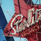 A painting of a red star sign and a blue building