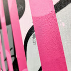 A close up of a pink and black abstract painting