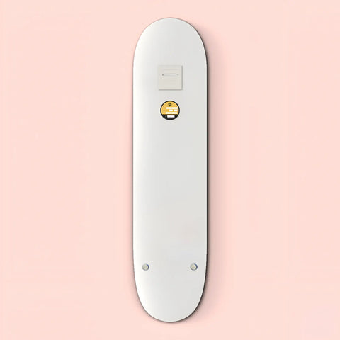 White electronic device resembling a sleek, elongated remote control with a small circular button.