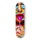 Skateboard deck featuring vibrant pop art-style imagery of lips, a lollipop, and abstract elements.